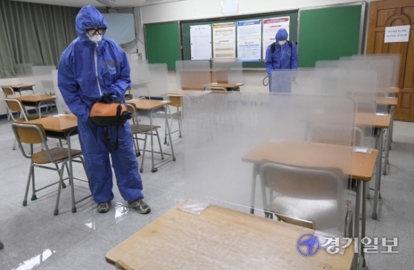 2021학년도 대학수학능력시험을 하루 앞둔 2일 오후 수원시 A고등학교에 마련된 시험실에서 방역 관계자들이 소독을 하고 있다. 조주현기자