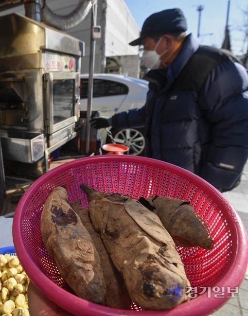 올겨울 들어 가장 추운 날씨를 보인 4일 오후 수원시 권선구 한 거리에서 상인이 군고구마와 군밤을 팔고 있다. 상인은 “군고구마는 날씨가 추울수록 잘 팔려요