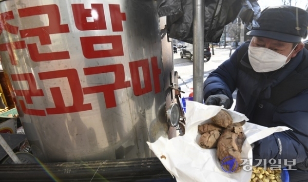 올겨울 들어 가장 추운 날씨를 보인 4일 오후 수원시 권선구 한 거리에서 상인이 군고구마와 군밤을 팔고 있다. 상인은 “군고구마는 날씨가 추울수록 잘 팔려요