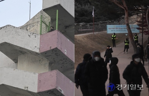 새해 첫날인 1일 오전 수원시 한 아파트에서 한 시민이 새해를 맞이하고 있다. 반면 코로나19 확산 방지를 위해 통제된 서장대에선 해맞이 인파가 몰렸지만 발걸음을 돌려야 했다. 조주현기자