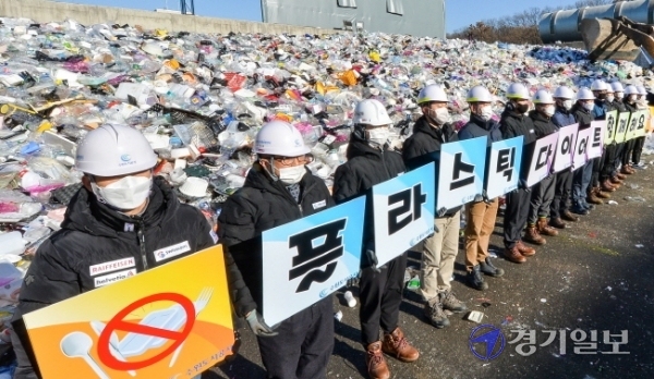 19일 오전 수원시자원순환센터 플라스틱 야외적치장에서 수원도시공사 임직원들이 '플라스틱 다이어트 함께 해요' 문구가 새겨진 피켓을 들고 '탈 플라스틱 캠페인'을 하고 있다.장용준기자