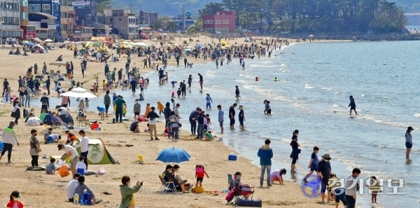 낮기온이 25도 가까이 오른 25일 오후 안산시 대부도 방아머리해수욕장이 물놀이 인파로 붐비고 있다. 화창한 날씨가 계속되면서 도내 유원지, 해수욕장마다 벌써부터 나들이객들이 몰리는 가운데 관광지에 대한 코로나19 예방 대책이 요구되고 있다.   윤원규기자