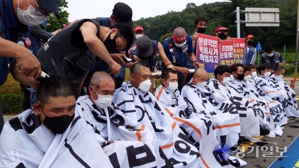 택배노조 경기지부 관계자들이 14일 오후 경기도청 앞에서 택배노동자 과로사 방지 및 분류작업의 택배사  시행 등을 촉구하며 단체삭발을 하고 있다.  김시범기자