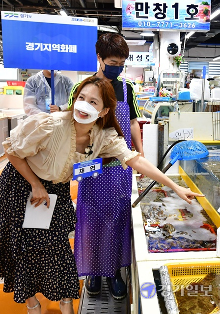 18일 오전 화성시 전곡항 일대에서 열린 '경기지역화폐 31개 시군 데이트 시즌2, 야호! 여름이다!!!'에서 개그맨 정태호와 가수 채연이 경기지역화폐 정책을 홍보하고 있다. 경기도는 지난 3~6월 시즌1을 통해 18개 시군을 방문했고, 이날부터 8월까지 시즌2로 나머지 13개 시군을 찾아가게 된다. 이번 편에서 정정호와 채연은 지역 소상공인을 만나 고충을 듣고, 경기지역화폐로 물건을 구매하는 등 현장에서 응원과 격려의 메시지를 보내 시청자의 큰 호응을 얻었다.조주현기자