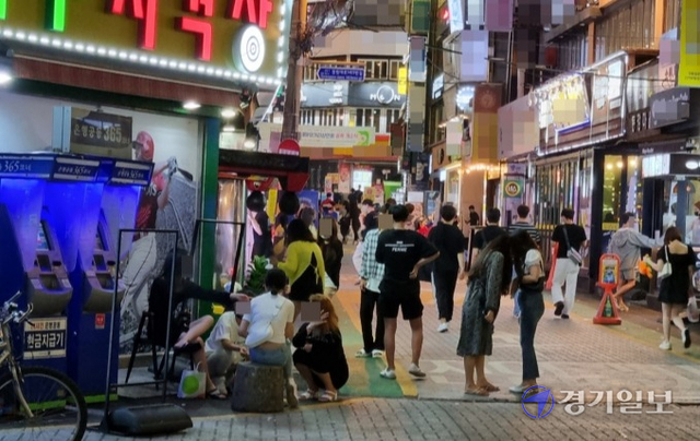 12일 오후 10시께 인천 부평구 부평동 테마의거리에서 20대 여성 3명과 남성 1명이 모여 앉아 담배를 피고 있다. 강우진기자