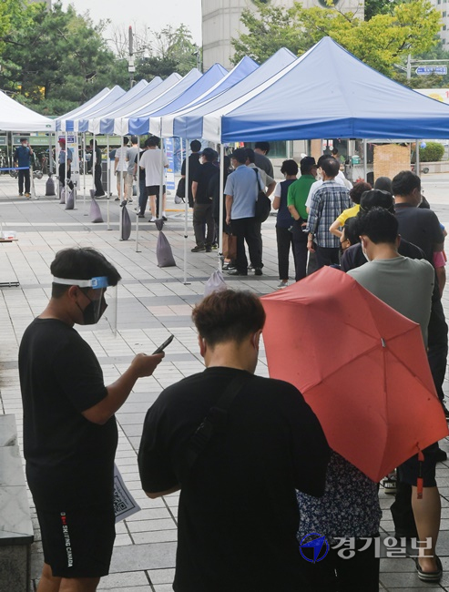코로나19 신규 확진자가 2,223명을 기록한 11일 오전 성남시 야탑역 임시선별진료소에서 검사를 받으려는 시민들이 줄지어 순서를 기다리고 있다. 윤원규기자