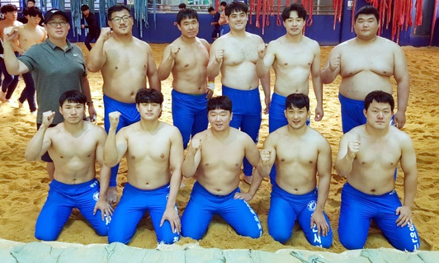 최근 3년동안 각종 대회서 25개의 금메달을 쓸어담으며 제2의 전성기를 맞이하고 있는 창단 17년의 용인시청 씨름단 선수들이 화이팅을 외치고 있다. 뒷줄 왼쪽이 장덕제 감독. 용인시청 제공