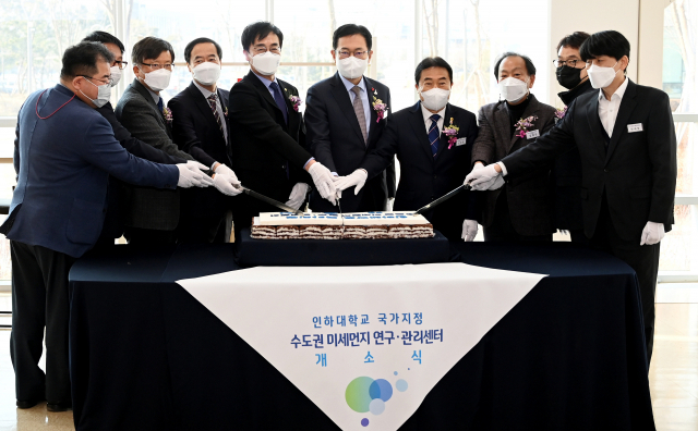 박남춘 인천시장이 20일 인천 연수구 인하대학교 항공우주융합캠퍼스에서 열린 '인하대학교 국가지정 수도권 미세먼지 연구·관리센터 개소식'에서 축하 떡 케이크를 자르고 하고 있다. 인천시 제공