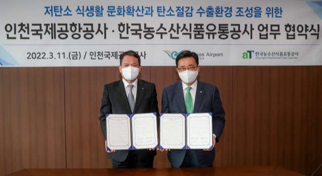 김경욱 인천국제공항공사 사장(왼쪽)이 ‘ESG 실천과 저탄소 식생활 문화 확산을 위한 인천국제공항공사-한국농수산식품유통공사(aT) 업무협약식’에서 김춘진 한국농수산식품유통공사(aT) 사장(사진 오른쪽)과 기념촬영을 하고 있다./인천공항공사 제공