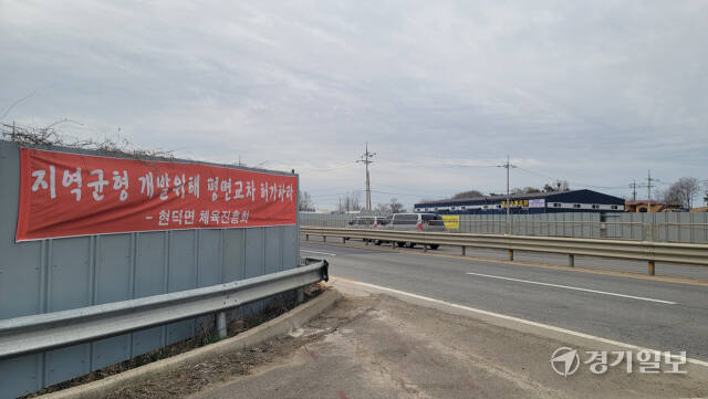 25일 평택시 현덕면 기산리 인근 장수교차로 공사 현장에 좌회전 구간 설치를 촉구하는 주민들의 현수막이 붙어있다. 안노연기자