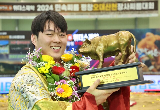 2024 민속씨름 평창 오대산천 장사씨름대회에서 개인 통산 두 번째 한라장사에 등극한 용인특례시청 박민교과 황소트로피를 들고 활짝 웃고 있다.대한씨름협회 제공