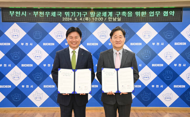 조용익 부천시장(왼쪽)과 김호 부천우체국장이 협약을 체결하고 기념촬영을 하고 있다. 부천시 제공.