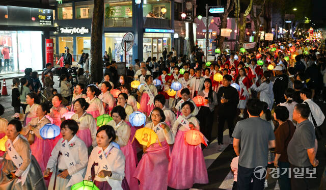 부처님 오신날을 앞두고 2024 수원연등축제가 열린 27일 오후 수원특례시 장안문 일대에서 불자들과 시민들이 연등을 들고 제등 행렬에 참여하고 있다. 윤원규기자
