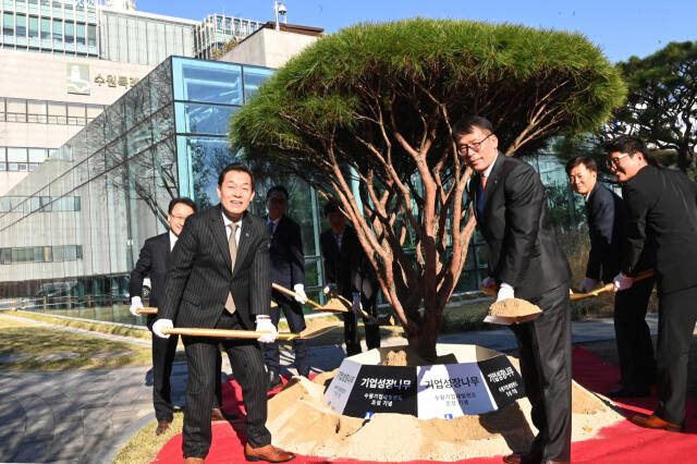지난해 11월 비전선포식에 앞서 수원특례시청 본관 정원에 수원기업새빛펀드 결성을 기념하는 ‘기업성장나무’를 심고 있다. 수원특례시 제공