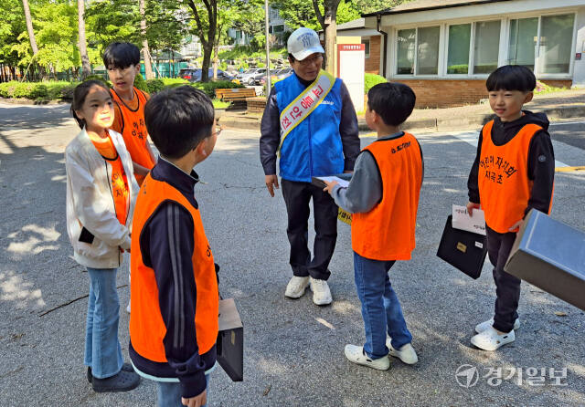 8일 오전 용인 기흥구 지곡초 앞에서 학생들이 어버이날을 맞아 교통안전 지킴이 어르신에게 감사 인사를 드리고 선물을 전달하고 있다. 송상호기자