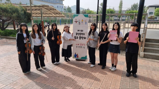 지난달 26일 양주 율정중 브릴란테 앙상블 클래식 단원들이 등굣길 음악회를 마친 뒤 지도교사와 함께 기념사진을 찍고 있다. 율정중 제공