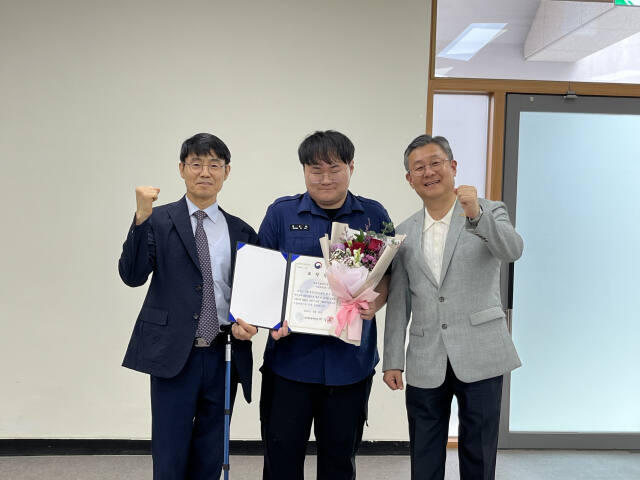 모범 사회복무요원으로 선정된 강병혁씨(가운데)가 허철회 경기북부병무지청장(왼쪽)으로부터 표창장을 받은 뒤 기념촬영을 하고 있다. 양주시 장애인종합복지관 제공