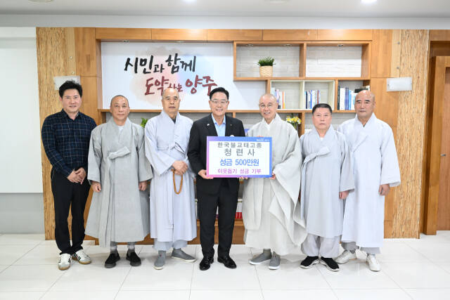 청련사 회주 성진스님을 비롯한 스님들이 강수현 양주시장에게 성금을 전달한 뒤 기념사진을 찍고 있다. 양주시 제공