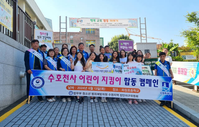 청소년 범죄예방위원 장안지구위원회는 13일 오전 수원 파장초교에서 ‘수호천사 어린이 지킴이 운동’ 등굣길 캠페인을 실시하고 기념촬영을 하고 있다. 장안지구위 제공
