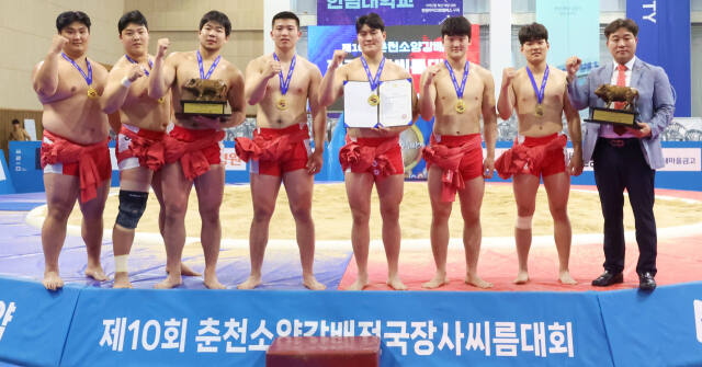 제10회 춘천소양강배 전국장사씨름대회에서 대학부 단체전 첫 우승을 차지한 경기대 홍성태 감독(오른쪽)과 선수들이 기념촬영을 하고 있다.대한씨름협회 제공