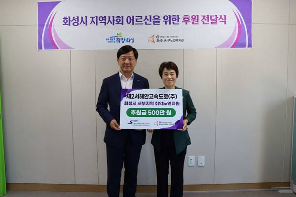 주현 제2서해안고속도로㈜ 대표이사와 박정숙 화성시서부노인복지관 관장 후원금 전달식을 갖고 기념촬영을 하고 있다. 제2서해안고속도로㈜ 제공