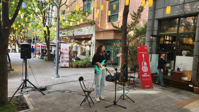 보정동카페거리에서 아임버스커로 활동하는 아티스트 도빛이 거리공연을 펼치고 있는 모습. 용인문화재단 제공