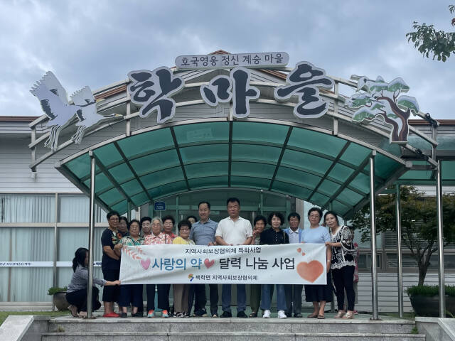 연천군 백학면지역사회보장협의체가 27일 취약계층 어르신들에게 ‘사랑의 약 달력’을 배포하고 기념 촬영을 하고 있다. 연천군 제공