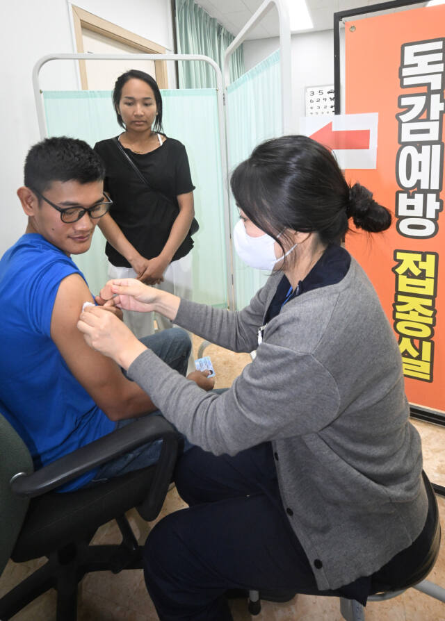 20일 오전 경기도의료원 수원병원 노동자 건강증진센터에서 언어장벽으로 의료 접근성이 낮은 외국인 노동자들이 독감(인플루엔자) 백신 예방접종을 받고 있다. 센터는 한국어 소통이 어려운 외국인 노동자들을 위해 다양한 언어의 문진표를 마련하고 외국인 노동자 지원센터에서 통역 서비스를 지원했다.조주현기자