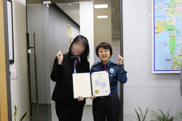 구리경찰서는 지난 25일 보이스피싱 피해를 예방한 국민은행 구리지점 직원 A씨에게 감사장을 수여한 후 오미애 서장과 은행원이 감사장을 들고 사진을 찍고 있다. 구리경찰서 제공