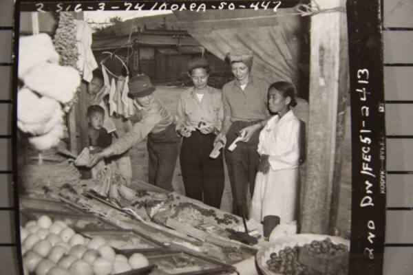 1950년 10월17일 미군의 여성 장교들이 여가를 이용해 경기도 수원의 한 시장을 방문해 구두와 복조리를 살펴보는 장면. 국사편찬위원회