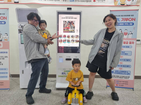경기도가 설치·운영 중인 ‘기부 키오스크’에 한 가족이 기부를 한 뒤 인증사진을 촬영하고 있다. 경기도 제공