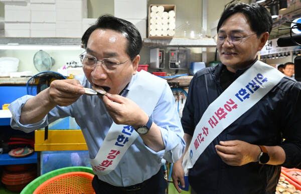유정복 인천시장이 북한 핵 오염수 방류 의혹과 관련해 30일 오전 인천 강화도 외포항 수산물 직판장에서 박용철 인천 강화군수와 구입한 백합을 시식하고 있다. 조병석기자