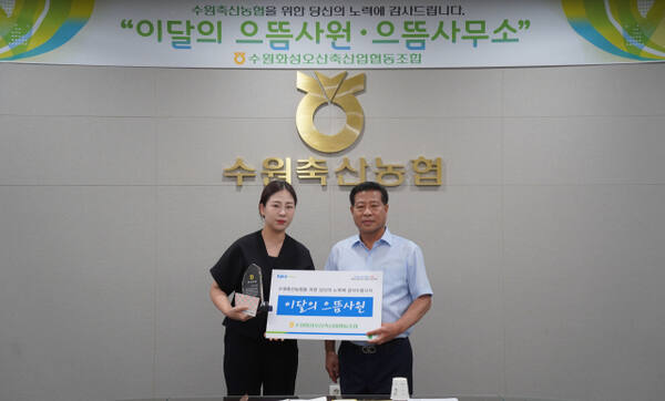 보이스피싱 사고를 예방한 수원축협 발안지점 이유경 계장(왼쪽)이 이달의 으뜸사원으로 선정돼 장주익 수원축협 조합장과 기념사진을 촬영하고 있다. 수원축협 제공