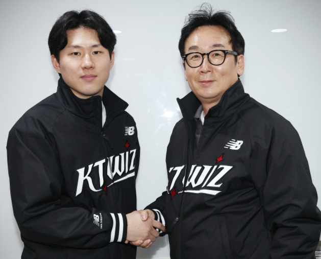 최원준(왼쪽)이 25일 KT 위즈와 FA 계약을 체결한 후 나도현 KT 단장과 기념촬영을 하고 있다. KT 제공